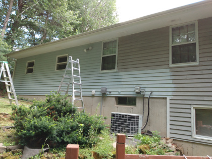 Combination ladders put up to paint other hard to reach areas of the house.