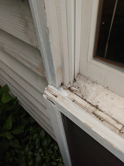 A rotted wooden window frame.