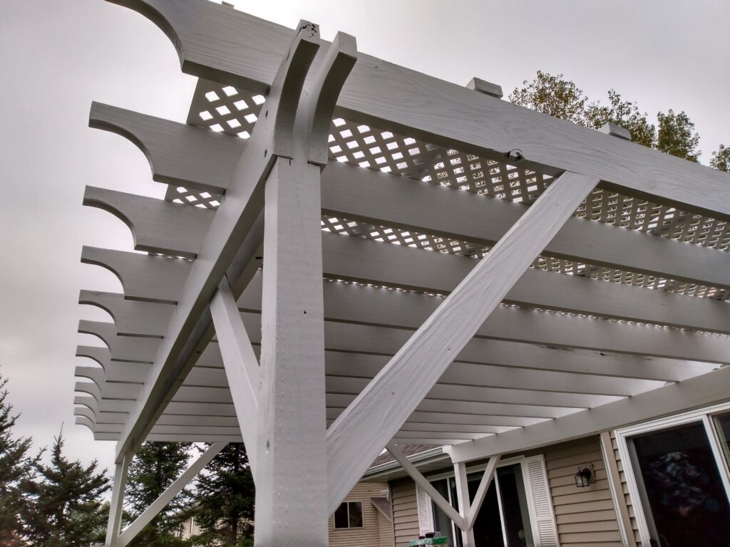 Shows pergola roof with lattice filtering the sky